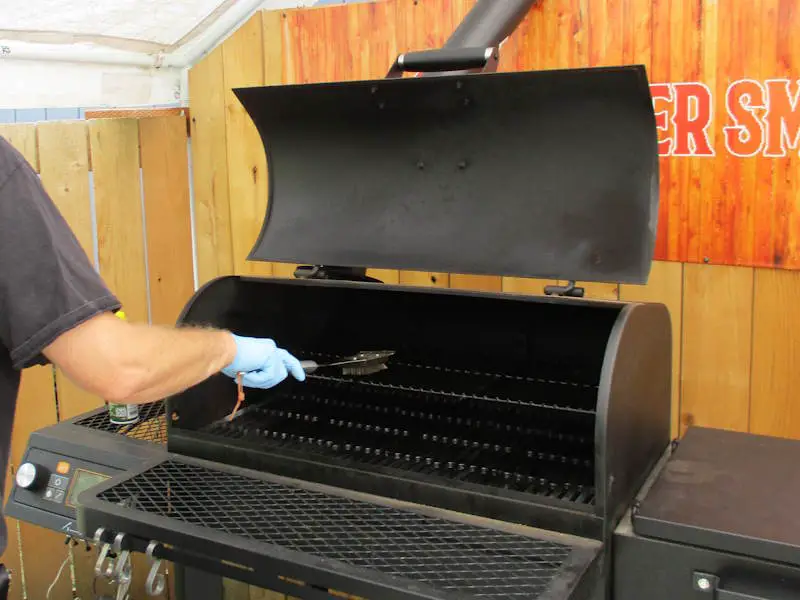 Tahoma 900 smoker grates being cleaned with a wire brush