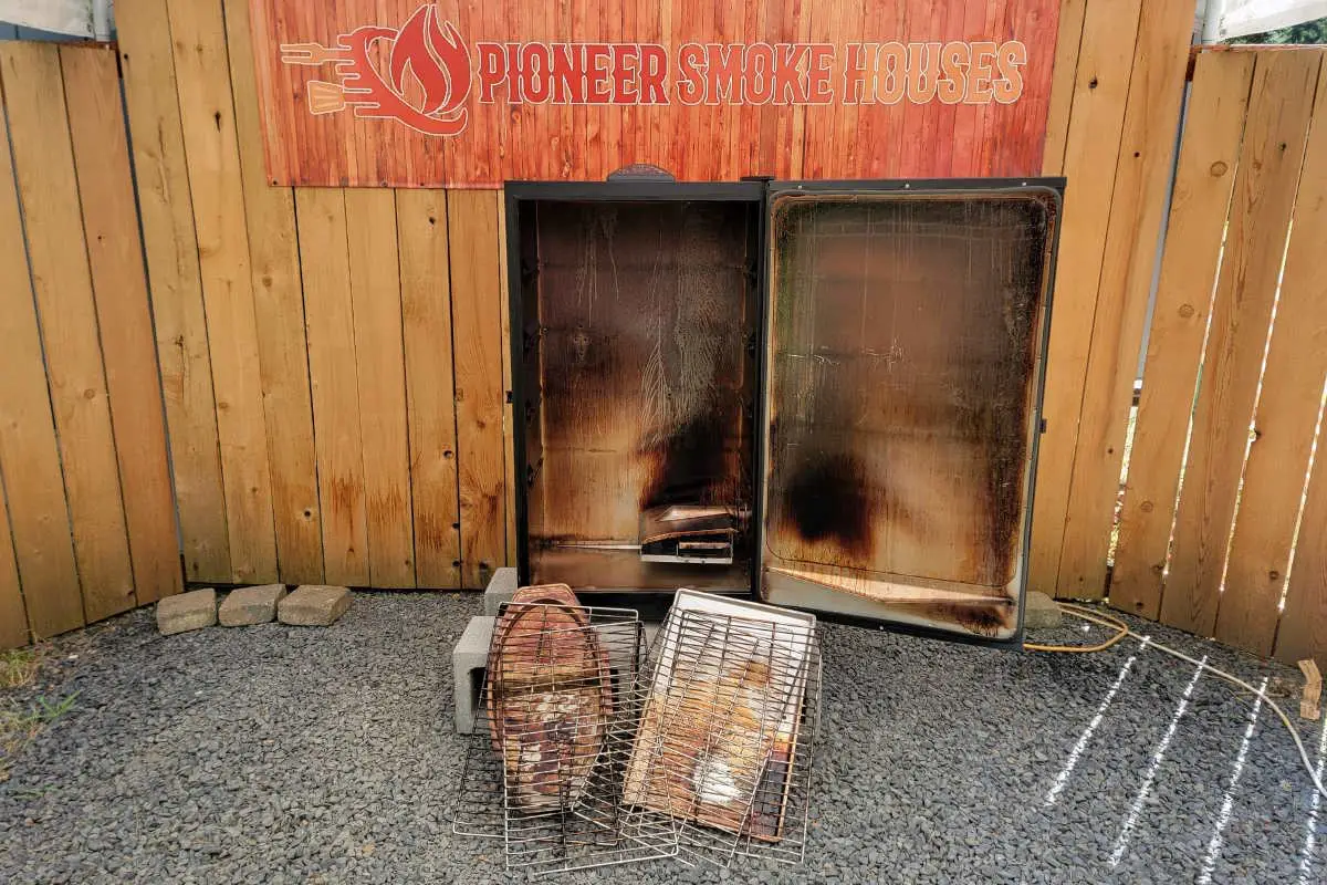 A clean Masterbuilt Electric Smoker with all parts laid out, showing racks, drip pan, water bowl, and interior walls