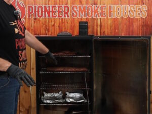 Placing the ribs on the middle rack of the smoker