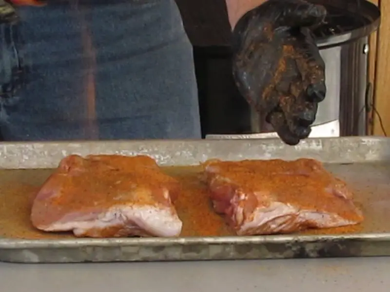 Raw turkey thighs with seasoning and rub