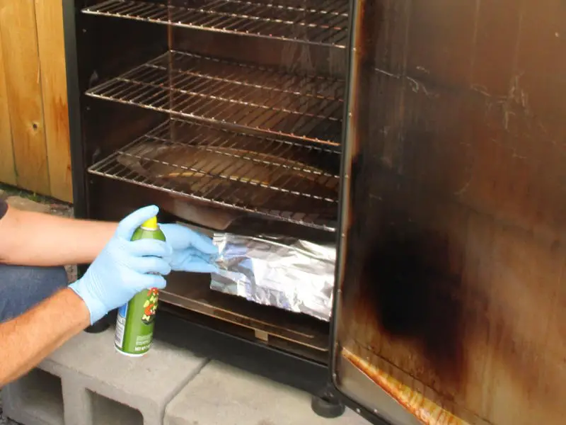 spraying the inside of the smoker with a piece of foil protecting the element